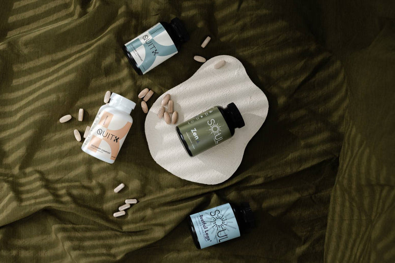Supplement bottles and pills on a textured surface